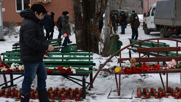 Люди несут цветы, свечи и мягкие игрушки к зданию торгового центра «Зимняя вишня» в Кемерово, где произошел пожар. 26 марта 2018