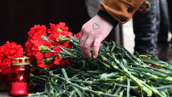Цветы в память о погибших в ТЦ Зимняя вишня у здания представительства Кемеровской области в Москве. 26 марта 2018