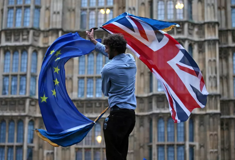 Участник протеста против Brexit возле здания парламента в Лондоне Участник протеста против Brexit возле здания парламента в Лондоне
