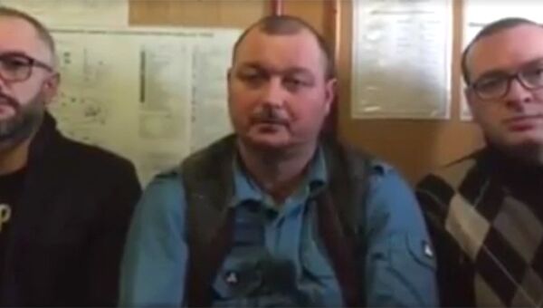 Капитан задержанного в Бердянске судна Норд Владимир Горбенко с адвокатами на стоп-кадре видеозаписи обращения, распространенного в социальных сетях
