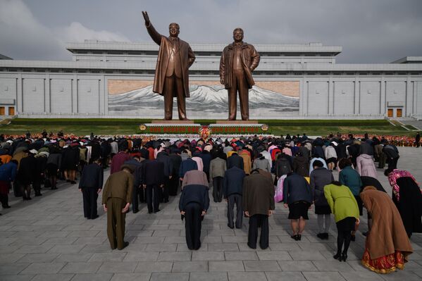Жители КНДР у монумента лидерам Ким Ир Сену и Ким Чен Иру. 15 апреля 2018