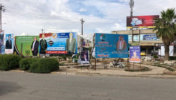 Предвыборные плакаты на улице Мосула в Ираке. 12 мая 2018