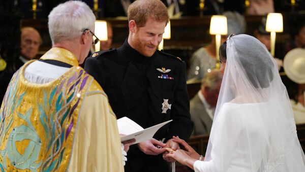 Британский принц Гарри и Меган Маркл во время свадебной церемонии в часовне Св. Георгия в Виндзорском замке недалеко от Лондона, Англия. 19 мая 2018