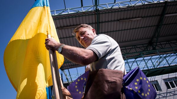 Мужчина с флагами Украины и Евросоюза на границе Словакии и Украины в районе КПП Ужгород-Вишне-Немецкое