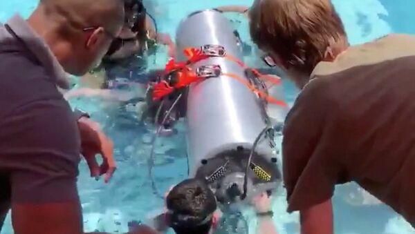 Устройство, созданное компаниями SpaceX и The Boring, принадлежащими Элону Маску, которое должно помочь спасти оставшихся членов футбольной команды из в затопленной пещеры, проходит испытания в бассейне в Лос-Анджелесе, Калифорния, США