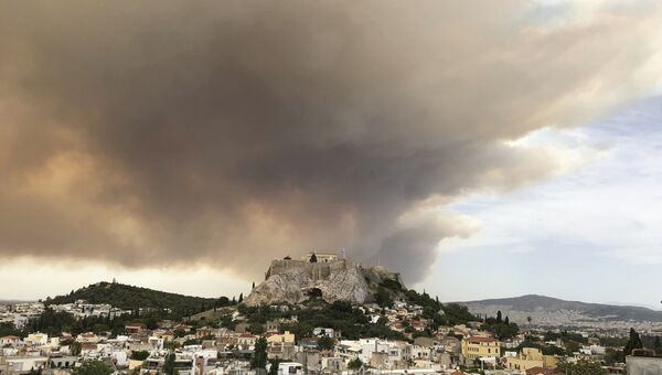 Дым от лесных пожаров над Акрополем в Афинах. 23 июля 2018 года