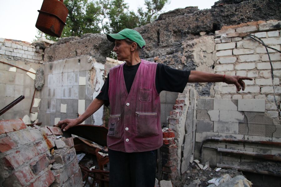 Женщина на руинах своего дома, поселок Веселое, Донецкая народная республика