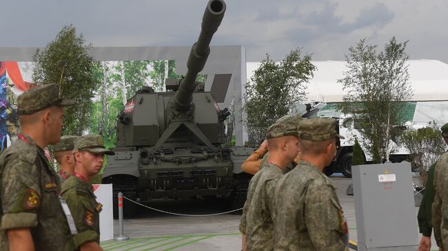 Военнослужащие на фоне самоходной артиллерийской установки Коалиция-СВ на форуме Армия-2018 в Кубинке