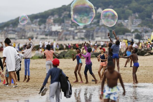 Дети играют на пляже в Кабур, Франция