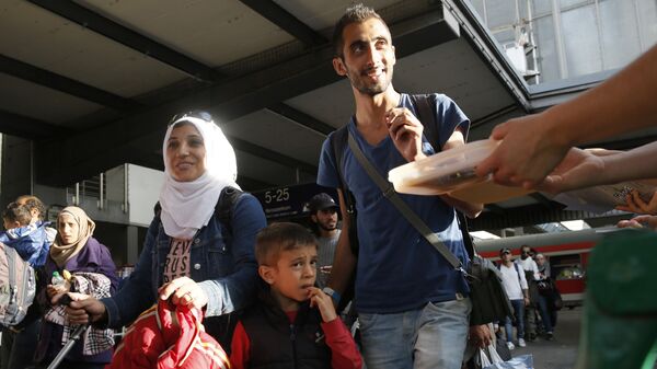 Беженцы из Сирии на центральном железнодорожном вокзале в Мюнхене
