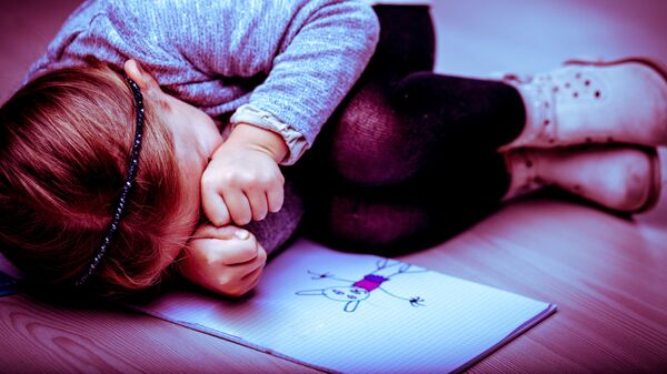 Маленькая девочка плачет на полу