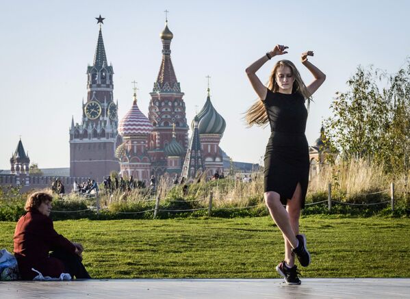 Девушка танцует в парке Зарядье в Москве