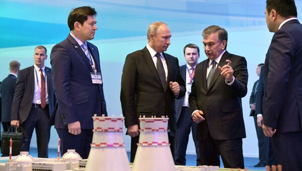 Президент РФ Владимир Путин и президент Узбекистана Шавкат Мирзиеев осматривают макет проекта строительства АЭС в районе озера Тудакуль