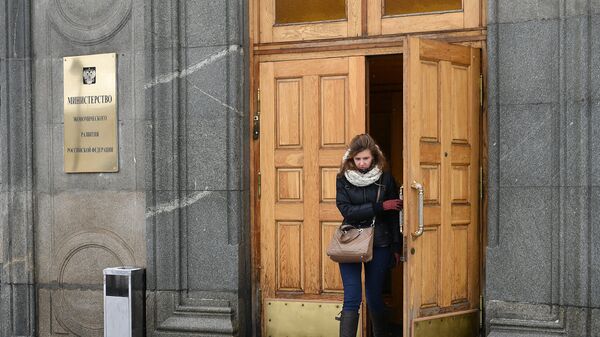 Женщина выходит из здания министерства экономического развития Российской Федерации