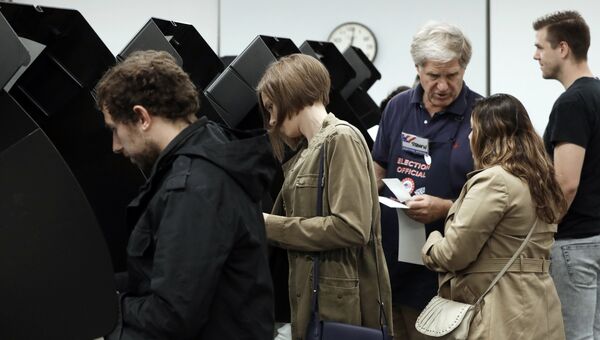 Избиратели во время голосования в публичной библиотеке города Вашингтона. 2 ноября 2018