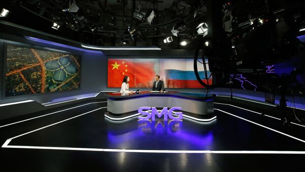Дмитрий Медведев и ведущая Юань Мин во время он-лайн конференции в студии штаб-квартиры Шанхайской медиагруппы. 5 ноября 2018