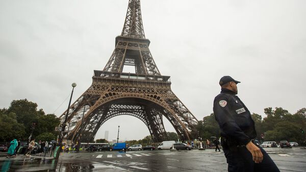 Сотрудник полиции возле Эйфелевой башни в Париже