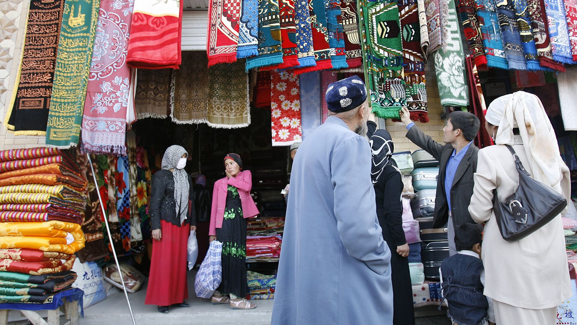 Уйгурские мусульмане выбирают молельные коврики на рынке в Хотане  - РИА Новости, 1920, 31.08.2022