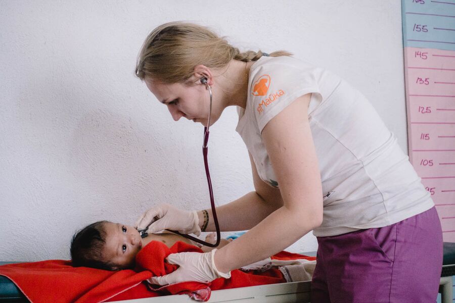 Врач осматривает ребенка в клинике Health&Help в Гватемале