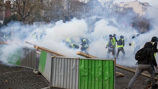 Столкновение участников акции протеста против роста цен на бензин желтые жилеты с силами правопорядка в Париже. 24 ноября 2018