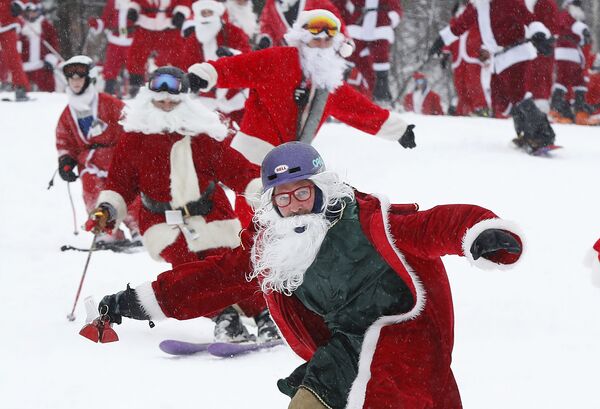 Лыжники и сноубордисты одетые как Санта-Клаус во время ежегодного мероприятия