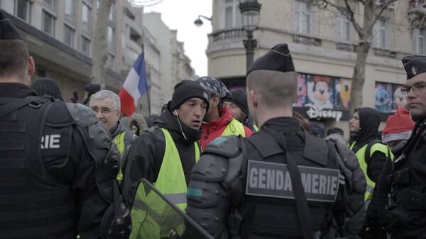 Сотрудники полиции и участники акции протеста движения автомобилистов желтые жилеты в районе Триумфальной арки в Париже