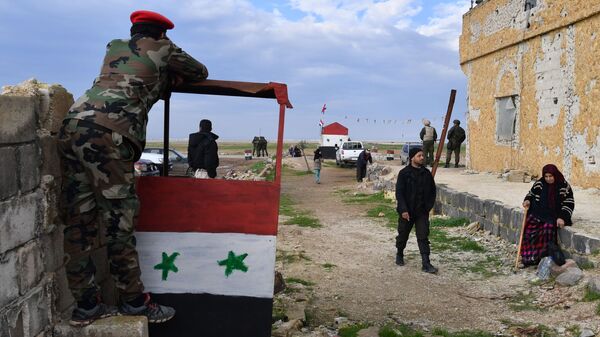 Военнослужащие и сирийские беженцы на территории гуманитарного коридора Абу-Духур в окрестностях провинции Идлиб