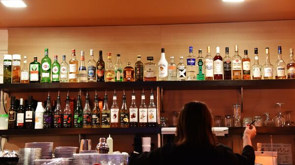 Алкогольные напитки и сиропы на полках бара