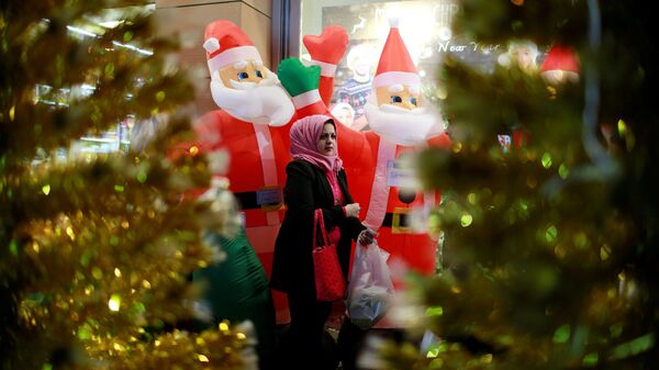 Женщина проходит мимо магазина, продающего рождественские украшения, в Багдаде, Ирак