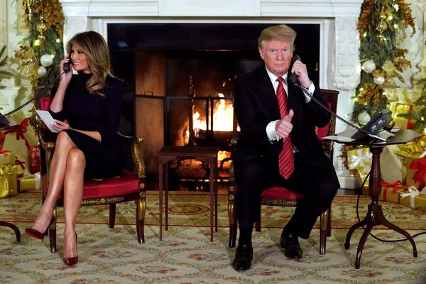Президент США Дональд Трамп и первая леди Меланья Трамп во время рождественской горячей линии 