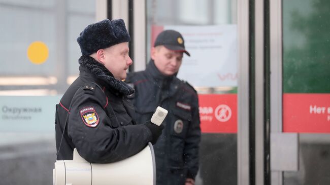 Сотрудник полиции у станции метро Окружная в Москве, закрытой из-за подтопления. 15 января 2019