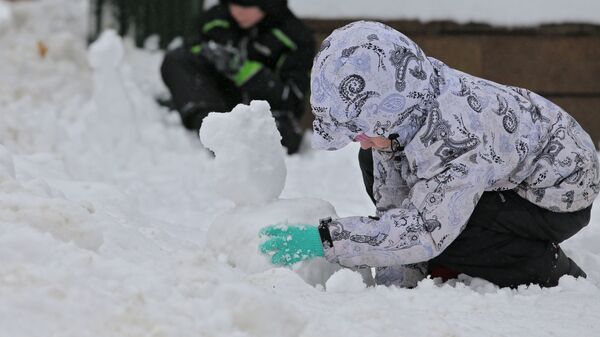 Юные жители Москвы лепят фигурки из снега
