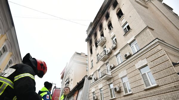 Сотрудники МЧС рядом с жилым домом на Никитском бульваре в Москве, где произошел пожар