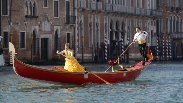 Люди на гондоле во время парада, посвященного началу карнавального сезона в Венеции