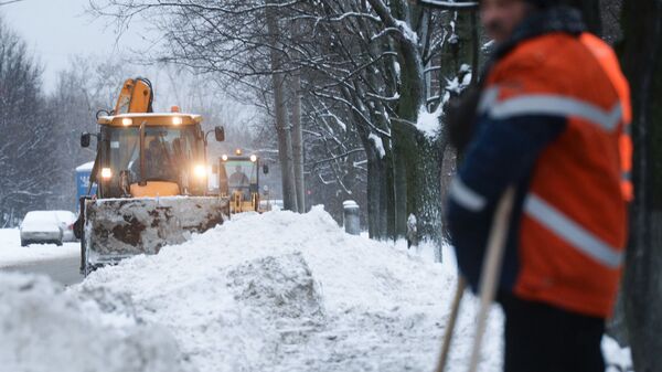 Сотрудники коммунальных служб убирают снег