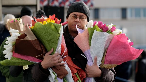 Мужчина с цветами на Рижском рынке в Москве