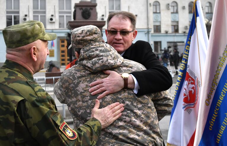 Люди поздравляют друг друга с 5-й годовщиной Общекрымского референдума 2014 года и воссоединения Крыма с Россией на одной из улиц в Симферополе