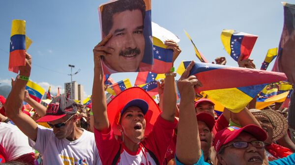 Участники во время акции в поддержку президента Венесуэлы Николаса Мадуро в Каракасе