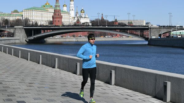 Мужчина совершает пробежку по набережной в Москве