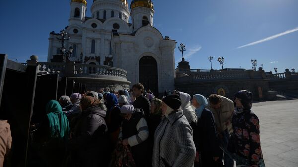 Верующие стоят в очереди к храму Христа Спасителя