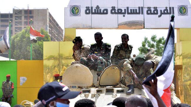 Суданские военные на бронетранспортере у здания Министерства обороны в Хартуме