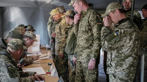 Украинские военнослужащие во время голосования на одном из избирательных участков в Донецкой области в день второго тура выборов президента Украины