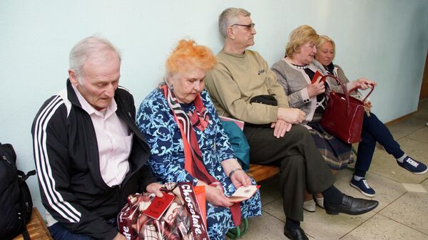 Жители Луганска сидят в очереди в отделении миграционной службы самопровозглашенной Луганской Народной Республики