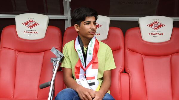 Герой снимка Желание жить, иракский мальчик Касим Алькадим во время посещения стадиона Открытие Арена в Москве. 12 мая 2019
