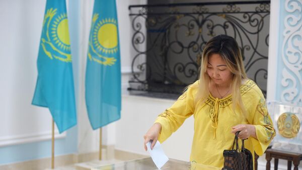 Женщина голосует на внеочередных выборах президента Казахстана в посольстве Казахстана в Москве. 9 июня 2019