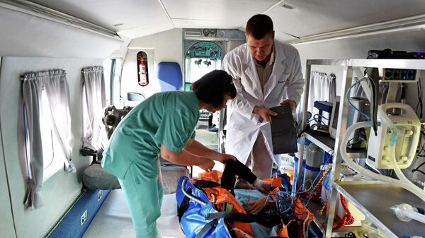 Сотрудники медицинской службы с пациентом на борту санитарного вертолета