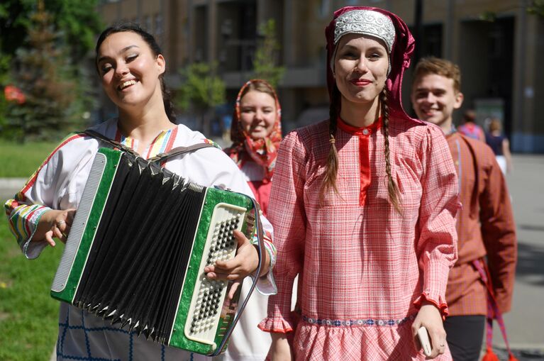 Молодые люди в национальных костюмах на Параде дружбы народов в парке им. М. Горького в Казани