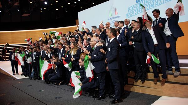 Italian delegation celebrates after International Olympic Committee (IOC) president Thomas Bach from Germany announced that Milan-Cortina was chosen to host the 2026 Winter Olympic Games