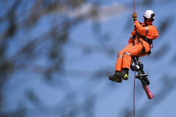 Спасатель-медик спускается на тросе с вертолета Ка-32А МАЦ во время учений