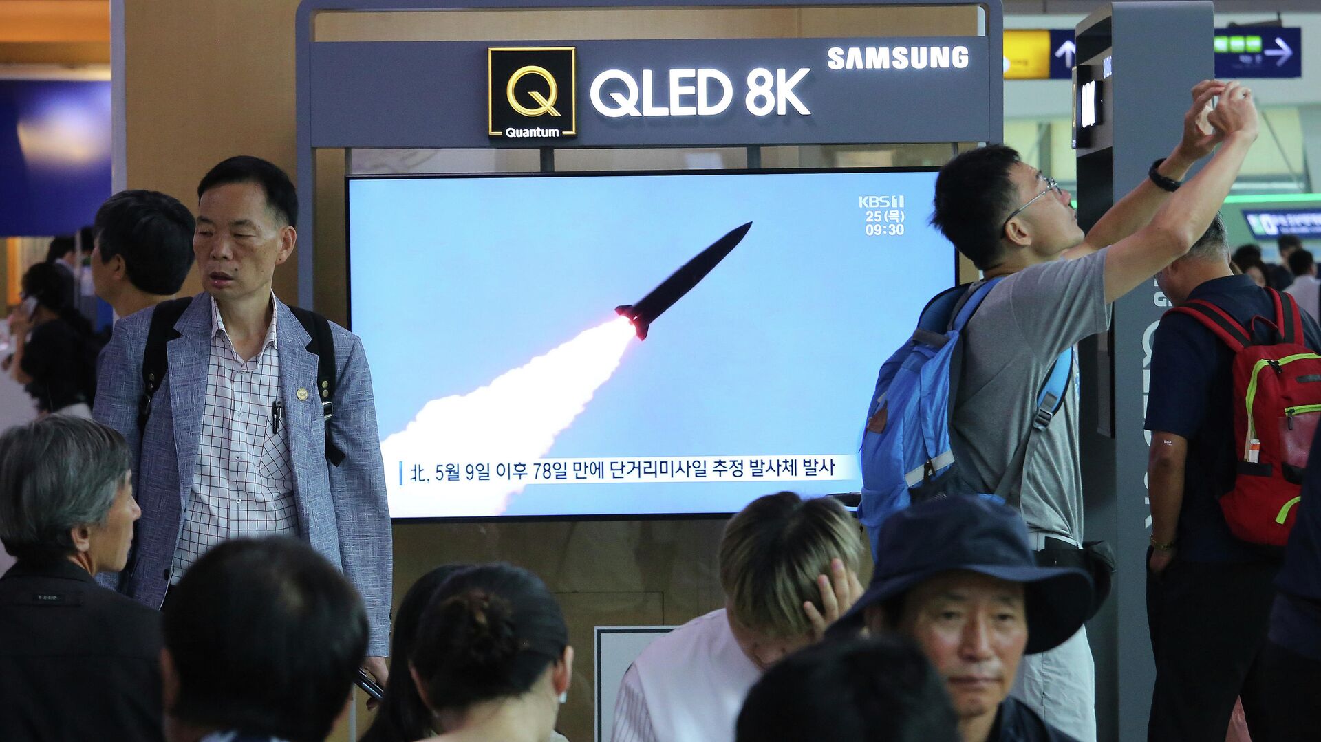 Жители Сеула смотрят по телевизору выпуск новостей о запуске ракет с территории КНДР. 25 июля 2019 - РИА Новости, 1920, 19.10.2021